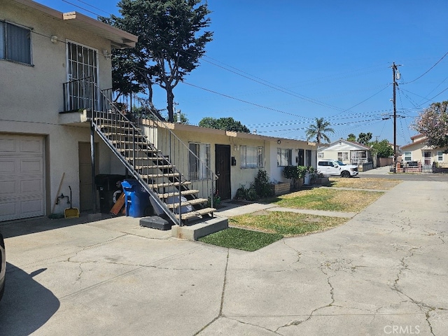 6704 Vinevale Ave, Bell, CA 90201 - view of front facade featuring stairs and stucco siding