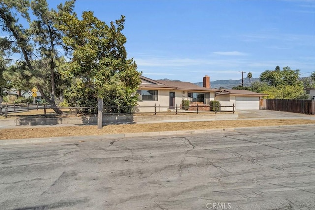 1487 Asbury Dr, Pasadena, CA 91104 - view of front of house featuring concrete driveway, an attached garage, a chimney, and stucco siding