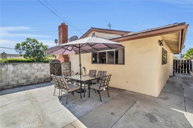 1487 Asbury Dr, Pasadena, CA 91104 - view of patio with a gate, fence, and outdoor dining space