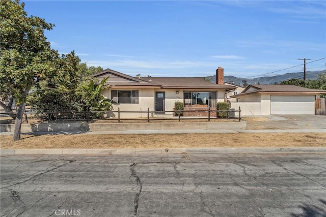 1487 Asbury Dr, Pasadena, CA 91104 - ranch-style house with a fenced front yard, stucco siding, driveway, a chimney, and an attached garage