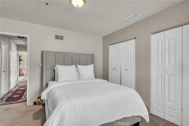 1487 Asbury Dr, Pasadena, CA 91104 - bedroom featuring multiple closets, a textured ceiling, and carpet