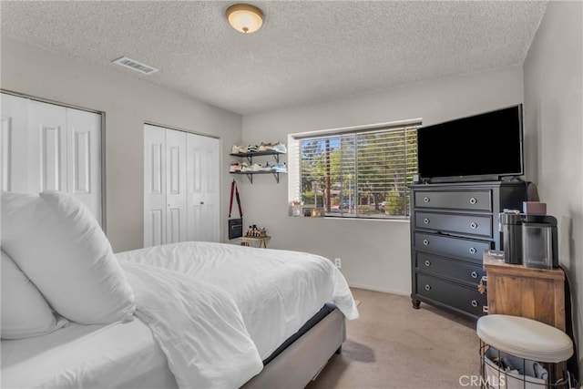 1487 Asbury Dr, Pasadena, CA 91104 - bedroom featuring carpet, a textured ceiling, multiple closets, and baseboards