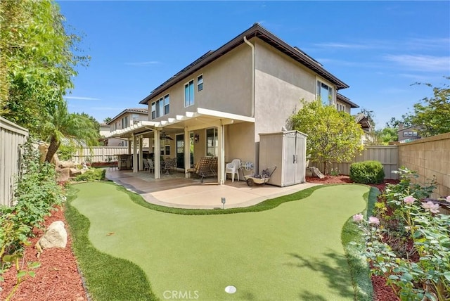 43376 Terra Ct, Temecula, CA 92592 - back of house with stucco siding, a putting green, a patio, and a fenced backyard