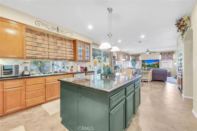 43376 Terra Ct, Temecula, CA 92592 - kitchen with green cabinets, tasteful backsplash, recessed lighting, a center island, and dark stone countertops