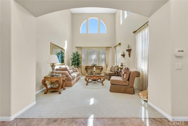 43376 Terra Ct, Temecula, CA 92592 - living room with arched walkways, baseboards, and a high ceiling