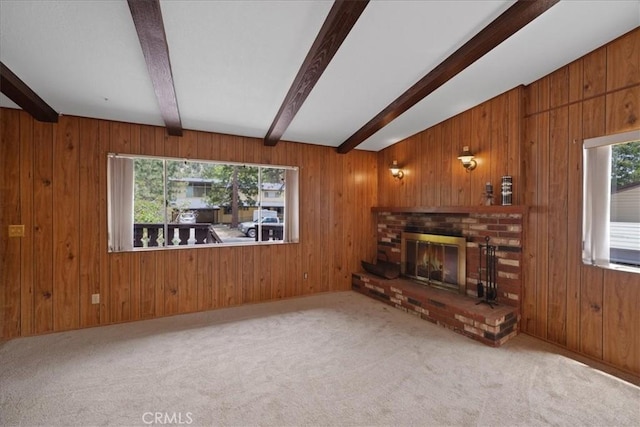 951 Snowbird Rd, Wrightwood, CA 92397 - unfurnished living room with beam ceiling, a brick fireplace, wooden walls, and carpet floors