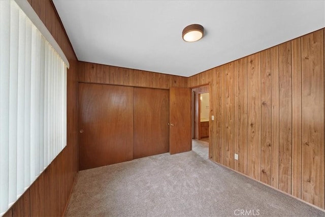 951 Snowbird Rd, Wrightwood, CA 92397 - unfurnished bedroom with a closet, wood walls, and carpet flooring