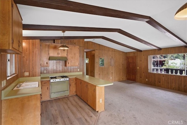 951 Snowbird Rd, Wrightwood, CA 92397 - kitchen with gas range gas stove, under cabinet range hood, light countertops, a peninsula, and wood walls