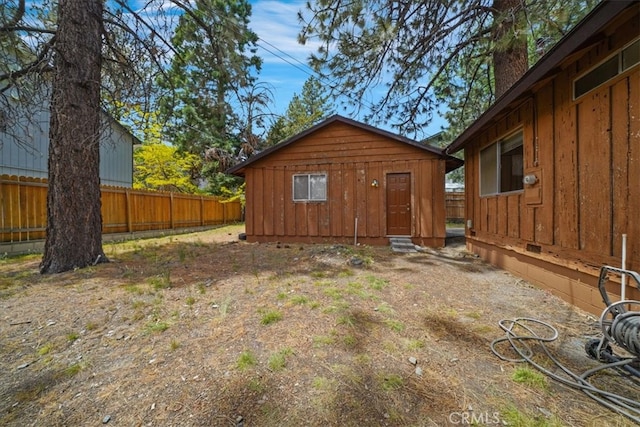 951 Snowbird Rd, Wrightwood, CA 92397 - rear view of house featuring a chimney, an outdoor structure, and entry steps