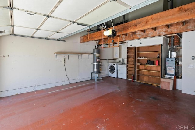 garage with washing machine and dryer, strapped water heater, and a garage door opener