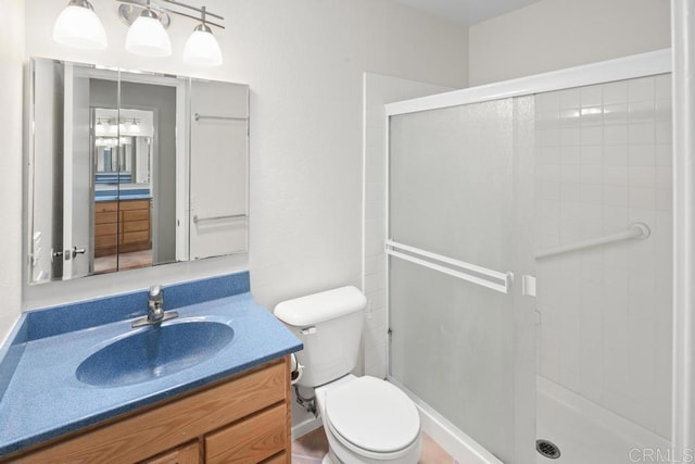full bath with a shower stall, toilet, and vanity