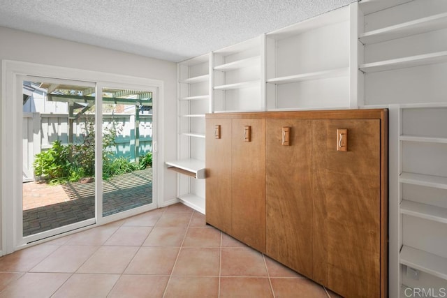 mudroom featuring a textured ceiling and light tile patterned floors