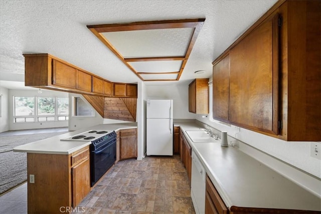 kitchen featuring white appliances, brown cabinets, a peninsula, light stone finish floors, and light countertops