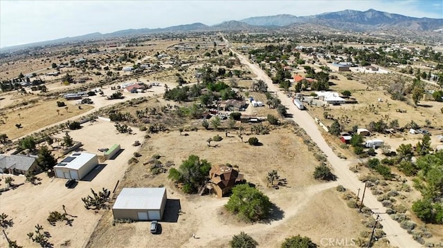 view of rural area with a desert landscape and a mountain backdrop
