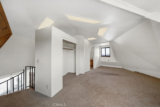 bonus room featuring carpet floors and vaulted ceiling