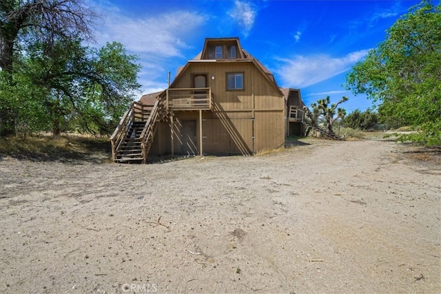 view of outbuilding featuring stairway
