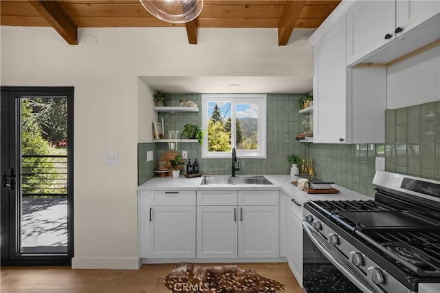 417 Delle Dr, Crestline, CA 92325 - kitchen with stainless steel gas stove, a sink, open shelves, light countertops, and backsplash