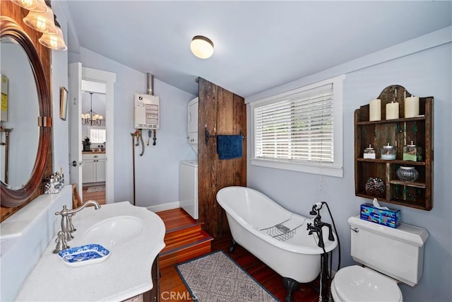 2013 3rd St, Julian, CA 92036 - full bathroom with stacked washer and clothes dryer, water heater, lofted ceiling, a soaking tub, and wood finished floors