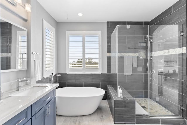 6407 Calmeria Pl, Carlsbad, CA 92011 - full bath with vanity, a freestanding tub, a shower stall, and tile walls