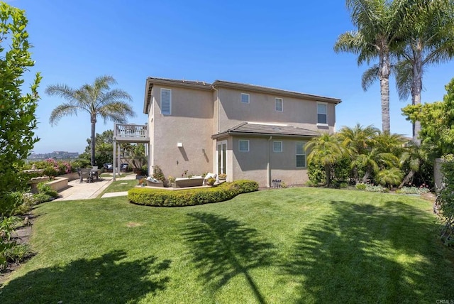 6407 Calmeria Pl, Carlsbad, CA 92011 - rear view of property featuring stucco siding, a balcony, a patio area, and a yard