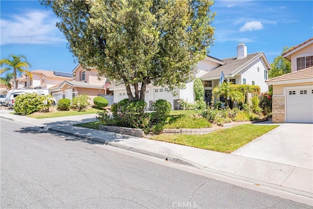 28229 Foothill Rd, Castaic, CA 91384 - view of property hidden behind natural elements featuring driveway, a garage, a residential view, and stucco siding