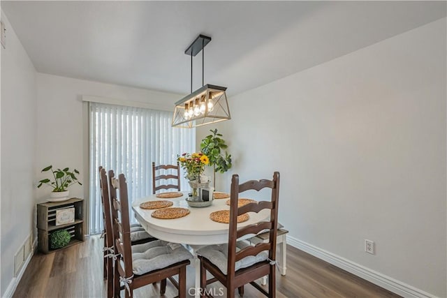 28229 Foothill Rd, Castaic, CA 91384 - dining space featuring wood finished floors, baseboards, and a chandelier