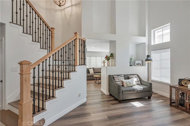 28229 Foothill Rd, Castaic, CA 91384 - stairs featuring a high ceiling, baseboards, wood finished floors, and a chandelier