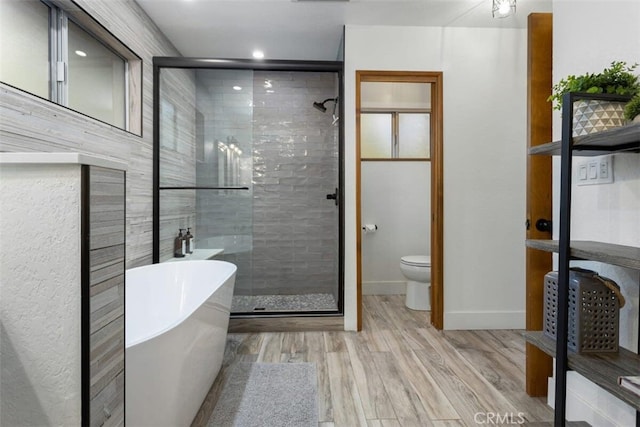 309 Golden Ln, Lake Arrowhead, CA 92352 - full bath featuring a shower stall, a freestanding tub, wood finished floors, toilet, and recessed lighting