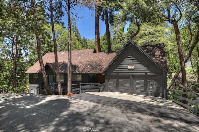 309 Golden Ln, Lake Arrowhead, CA 92352 - view of front of home with asphalt driveway, an attached garage, and a shingled roof