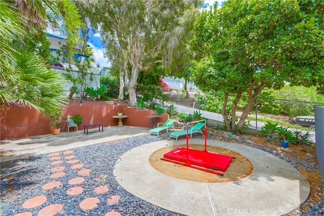 view of yard with fence and a patio