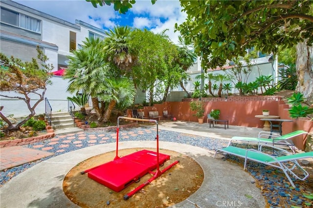 view of swimming pool with a patio area and fence