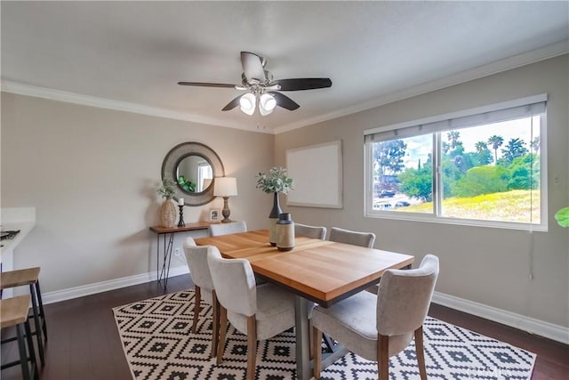 dining area featuring ceiling fan, dark wood-type flooring, baseboards, and ornamental molding
