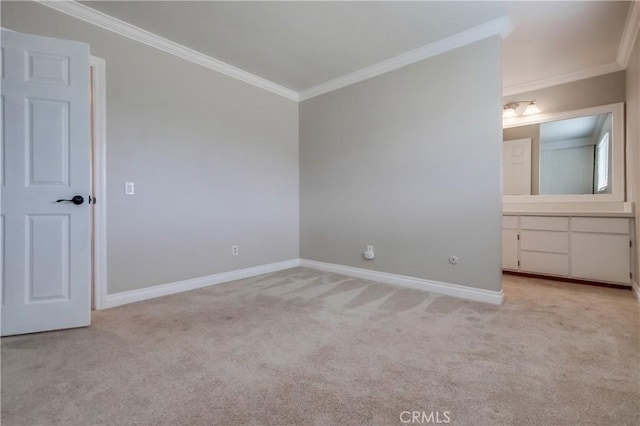 carpeted empty room featuring ornamental molding and baseboards