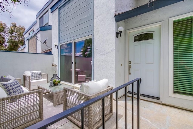 view of patio featuring an outdoor hangout area and fence