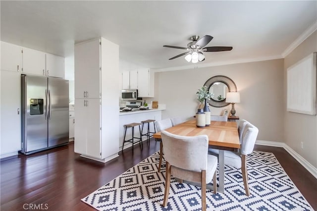 dining room with dark wood finished floors, ceiling fan, ornamental molding, and baseboards