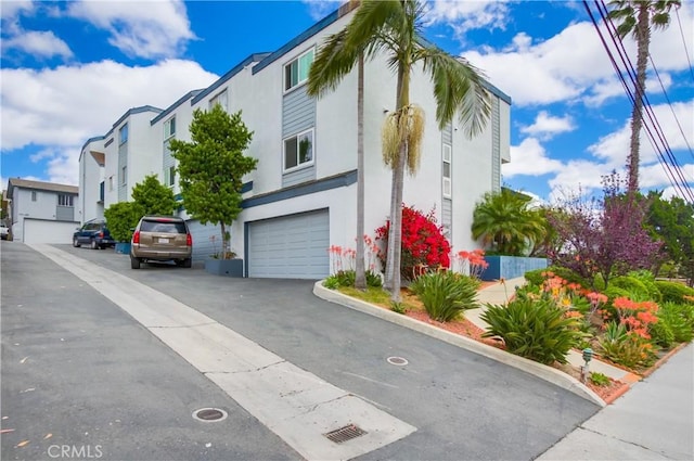 5573 Kiowa Dr, La Mesa, CA 91942 - view of front of property with stucco siding, a garage, asphalt driveway, and a residential view
