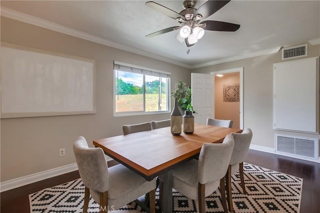 dining area with baseboards, dark wood finished floors, crown molding, and a ceiling fan