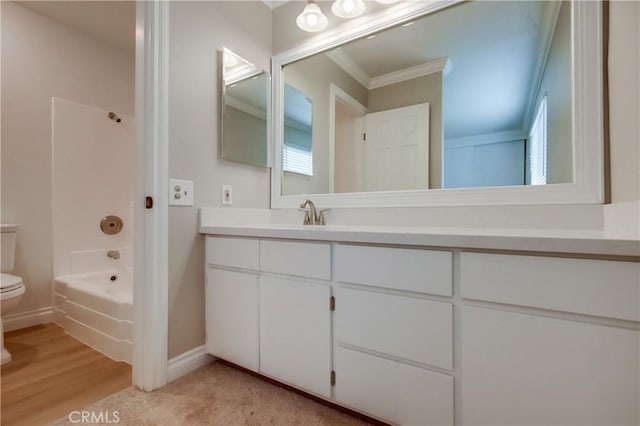 full bathroom with toilet, vanity, crown molding, bathtub / shower combination, and baseboards