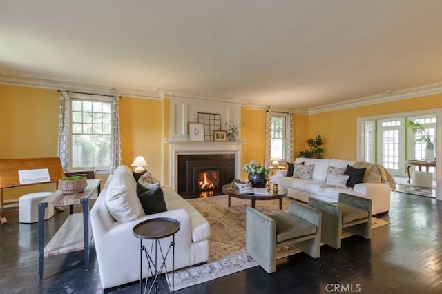 605 E Home Ave, Fresno, CA 93728 - living area featuring ornamental molding, healthy amount of natural light, wood finished floors, and a fireplace with flush hearth