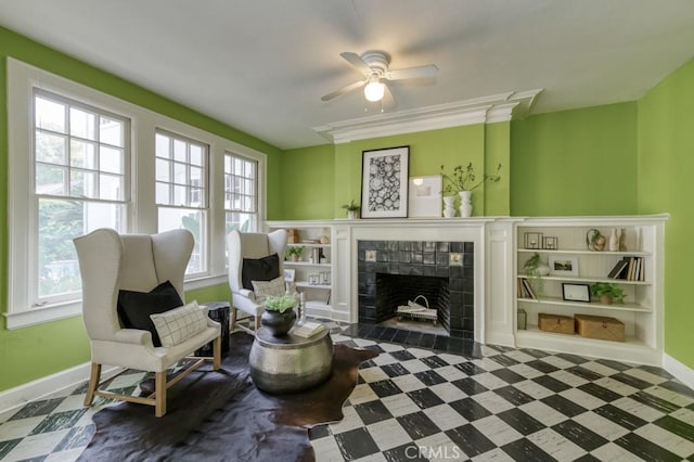 605 E Home Ave, Fresno, CA 93728 - sitting room with baseboards, a fireplace, ceiling fan, and tile patterned floors
