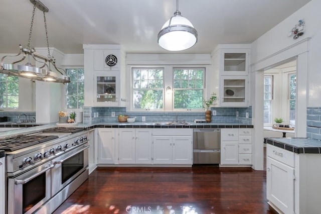 605 E Home Ave, Fresno, CA 93728 - kitchen featuring tile counters, stainless steel appliances, white cabinetry, a sink, and tasteful backsplash