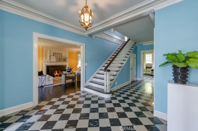 605 E Home Ave, Fresno, CA 93728 - foyer entrance featuring stairs, dark flooring, baseboards, a warm lit fireplace, and ornamental molding