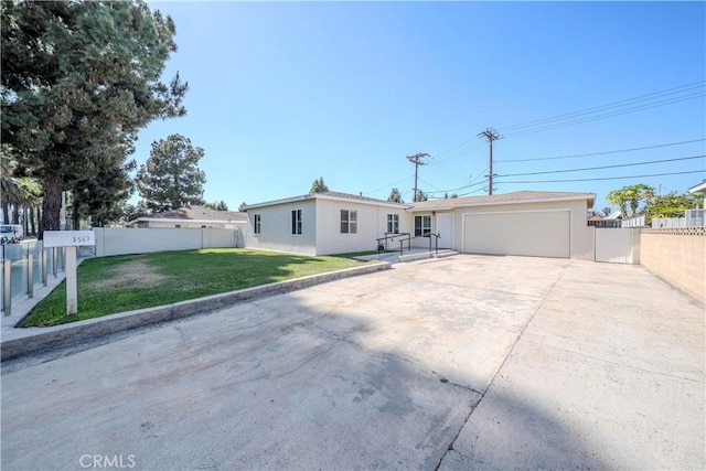 1517 W Romneya Dr, Anaheim, CA 92801 - view of front of home featuring a garage, driveway, and stucco siding