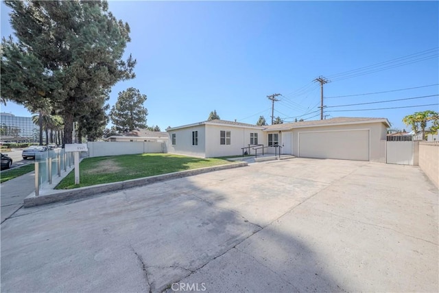 1517 W Romneya Dr, Anaheim, CA 92801 - ranch-style house with an attached garage, stucco siding, driveway, and an outdoor structure