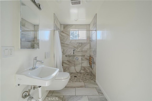 1517 W Romneya Dr, Anaheim, CA 92801 - full bath featuring tiled shower, toilet, marble finish floors, a sink, and baseboards