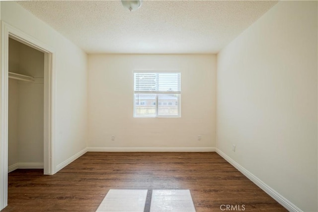1517 W Romneya Dr, Anaheim, CA 92801 - unfurnished bedroom with wood finished floors, a textured ceiling, a closet, and baseboards