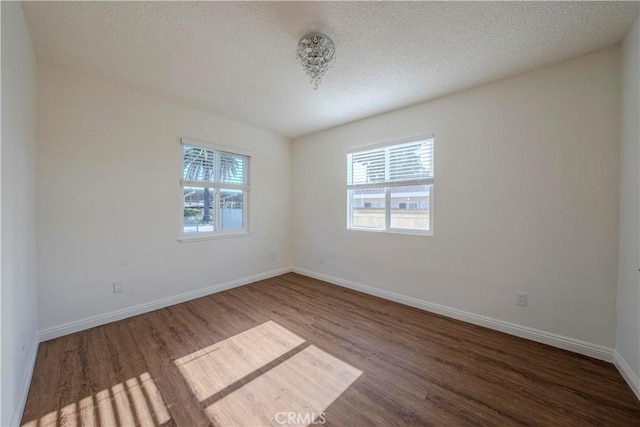 1517 W Romneya Dr, Anaheim, CA 92801 - empty room with healthy amount of natural light, wood finished floors, baseboards, and a textured ceiling