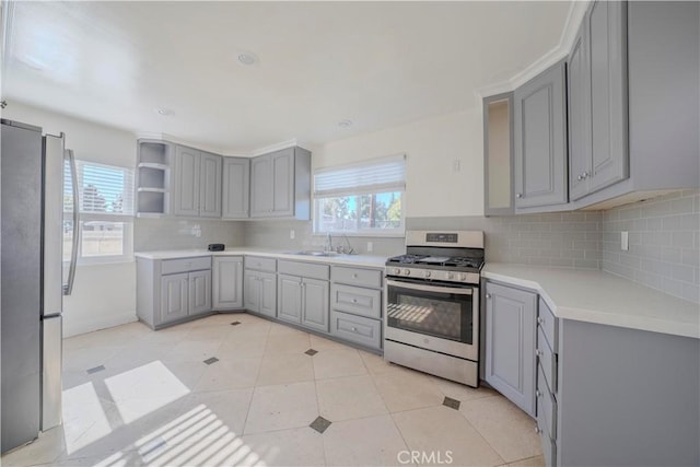 1517 W Romneya Dr, Anaheim, CA 92801 - kitchen with gray cabinets, appliances with stainless steel finishes, a sink, tasteful backsplash, and open shelves