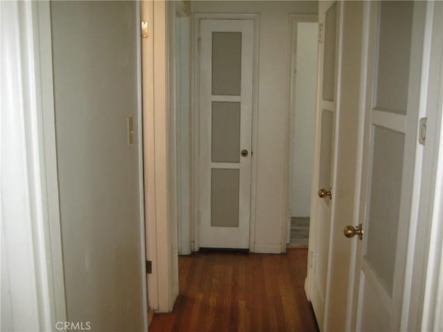 corridor featuring dark wood-style flooring