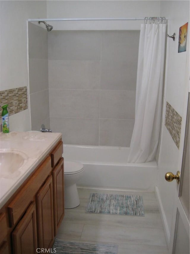 full bath featuring shower / tub combo, vanity, and toilet